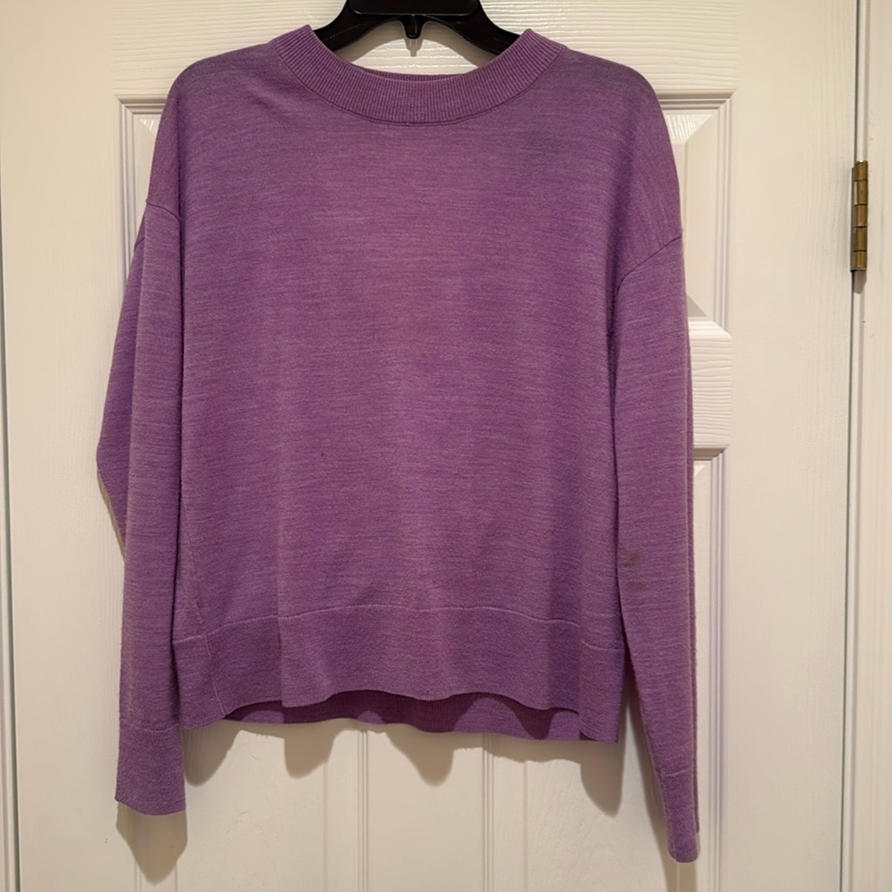 Jewel neck sweater with key hole back.